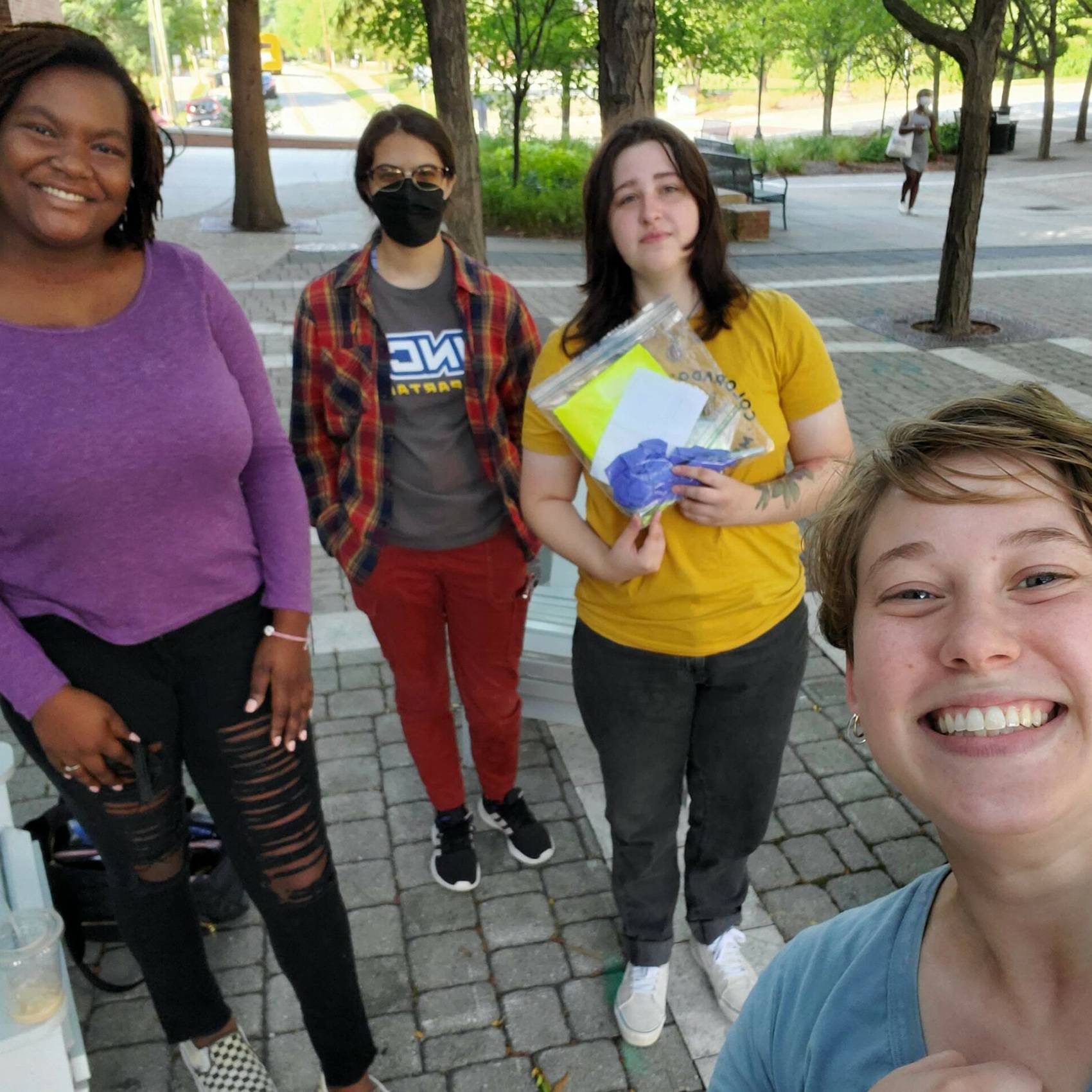 Photo of four students on campus.