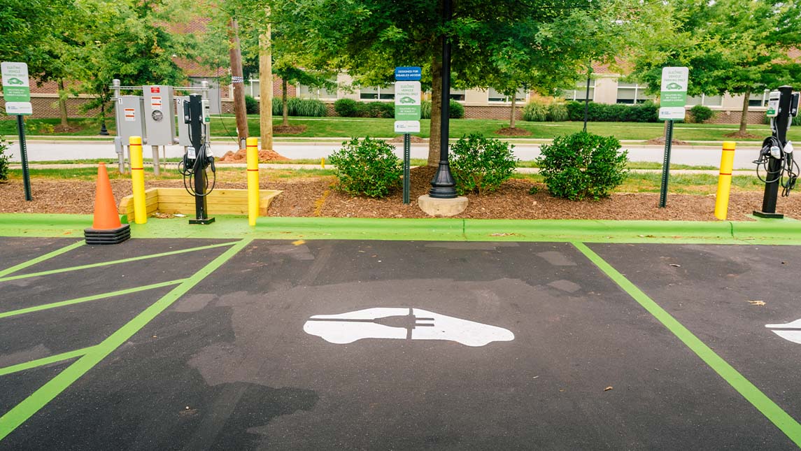 A picture of an electric vehicle charging station near the Kaplan Center.